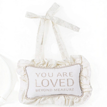Mellow Monkey taupe cotton canvas door hanger with You Are Loved Beyond Measure embroidery and ruffle trim