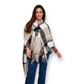 Mellow Monkey Alora taupe plaid wrap with fringed edges and front loop closure worn by a woman in jeans