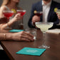 Mellow Monkey teal cocktail napkin with white text saying And then the tequila whispered on a table with drinks