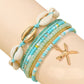 Mellow Monkey teal beaded bracelet set with seashell and gold starfish charms for a bohemian beach style look.
