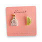 Mellow Monkey handmade tequila bottle and lime wedge stud earrings on a pink display card held in a hand.