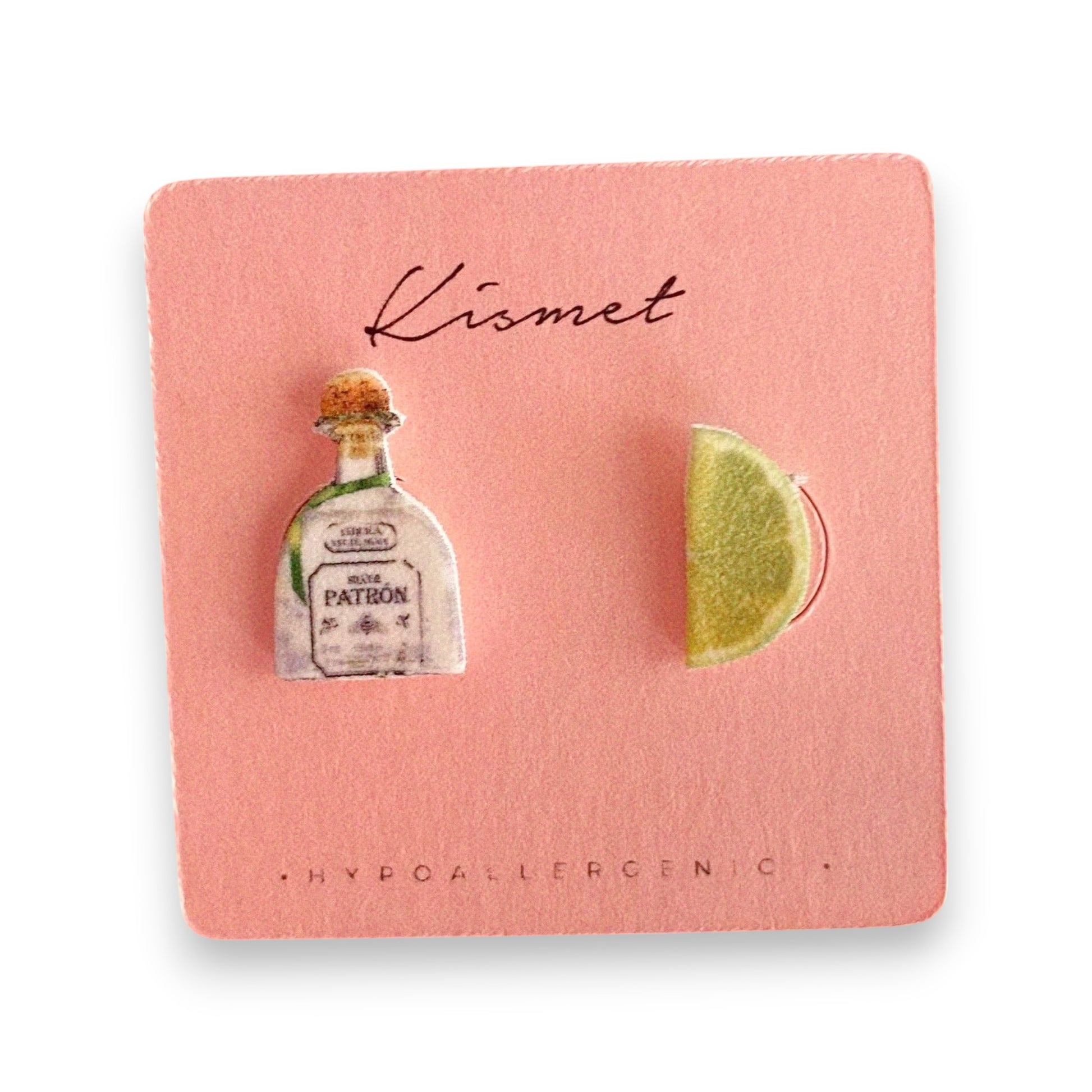 Mellow Monkey handmade tequila bottle and lime wedge stud earrings on a pink display card held in a hand.