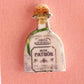 Mellow Monkey handmade tequila bottle and lime wedge stud earrings on a pink display card with stainless steel posts.