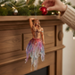 Mellow Monkey December Diamonds Testy Tenticles merman ornament with iridescent tentacles hanging on a fireplace mantel