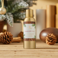 Mellow Monkey Thymes Frasier Fir home fragrance mist in a gold bottle with wood grain label on a rustic wooden table.