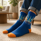 Mellow Monkey blue bamboo knit socks featuring a Times Square New York city skyline and yellow taxi graphic design