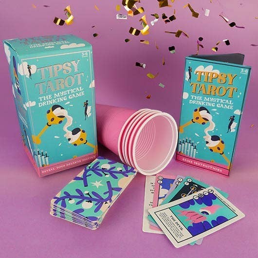 Mellow Monkey Tipsy Tarot drinking game set with teal box, instruction booklet, pink plastic cups, and tarot cards.
