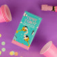 Mellow Monkey Tipsy Tarot drinking game box on a purple background with pink party cups and confetti