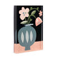 Mellow Monkey Together Tile Acrylic Wall Art, 5x7 inches, featuring a blue vase with pink flowers and green leaves on a black background with a pink base.