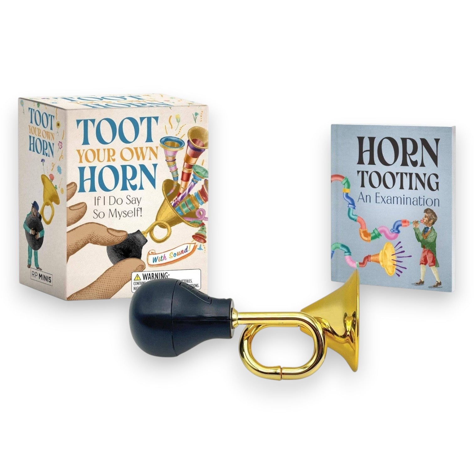 Mellow Monkey Toot Your Own Horn mini kit featuring a gold-colored toy horn with a black bulb and a 32-page book.