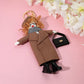 Mellow Monkey fashion doll keychain with trench coat, scarf, boots, and handbag. Camel color.
