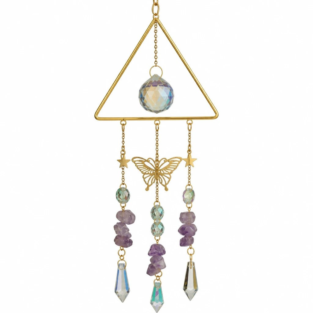 Mellow Monkey triangle suncatcher with crystals, amethyst stones, butterfly charm, and gold chains hanging in a window.