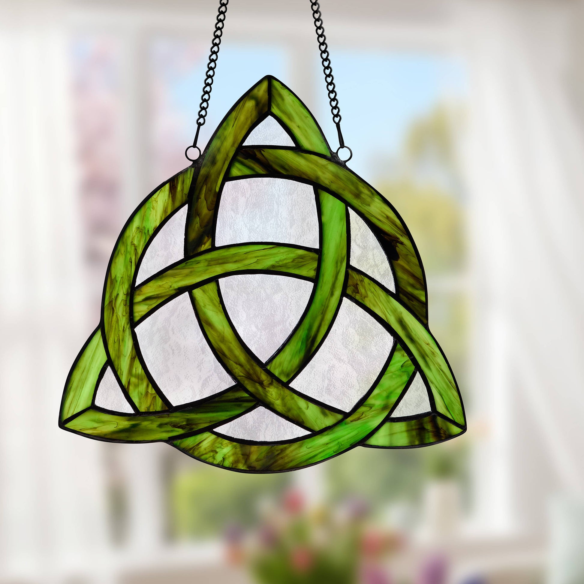Mellow Monkey Trinity Knot stained glass window panel in emerald green and clear glass with a metal hanging chain.
