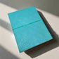 Mellow Monkey turquoise leather journal with debossed geometric pattern and elastic closure. Unlined pages.