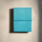 Mellow Monkey turquoise leather journal with debossed corners and elastic closure, 8x6 inches, unlined pages.