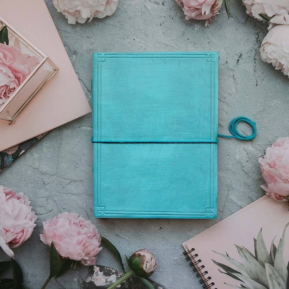 Mellow Monkey turquoise leather journal with debossed corners and elastic closure, unlined pages, 8x6 inches.