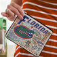 Mellow Monkey University of Florida zip pouch with woven Gator mascot and Gainesville landmarks on durable polyester