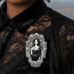 Mellow Monkey Vampira enamel pin in a silver gothic frame, worn on a black lace shirt.