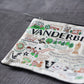 Mellow Monkey Vanderbilt University woven zip pouch with colorful embroidered campus landmarks, mascot, and school name. Polyester.