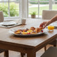 Mellow Monkey VIDA Havana Oval Tray in white, made of luxury melamine, serving pastries and fruit on a wooden table.