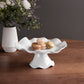 Mellow Monkey VIDA Havana white melamine pedestal cake plate with ruffled edge, 10.5in, holding macarons.