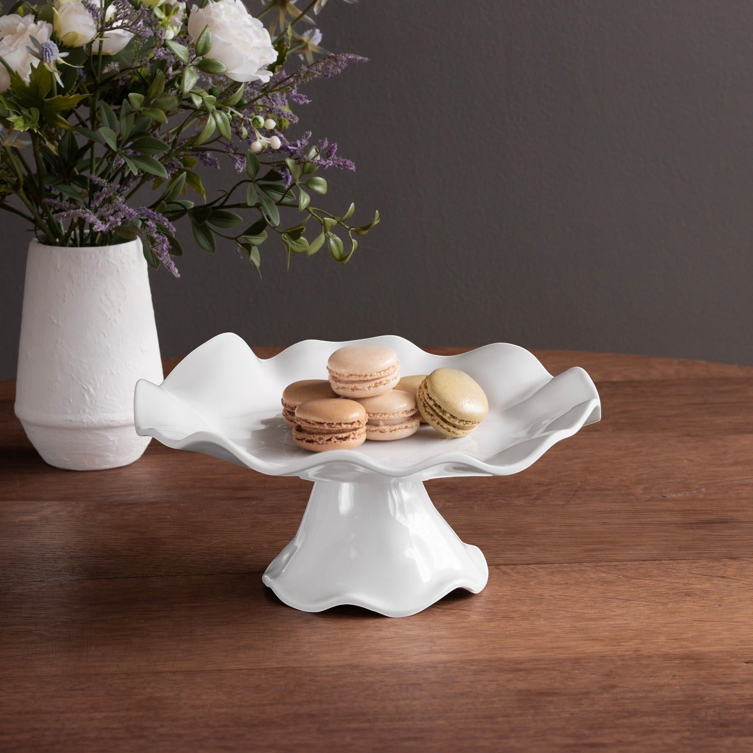 Mellow Monkey VIDA Havana white melamine pedestal cake plate with ruffled edge, 10.5in, holding macarons.