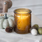 Mellow Monkey set of 4 vintage amber glass tea light holders with embossed fleur-de-lis pattern and warm candle glow.