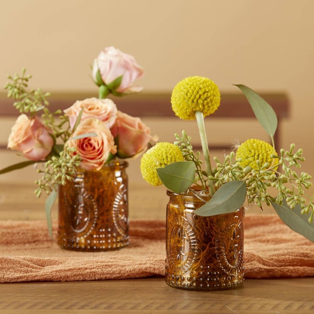 Mellow Monkey vintage amber glass tea light holders styled as floral vases with pink roses and yellow billy balls