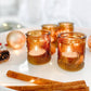 Mellow Monkey set of 4 vintage amber glass tea light holders with embossed patterns on a festive tabletop