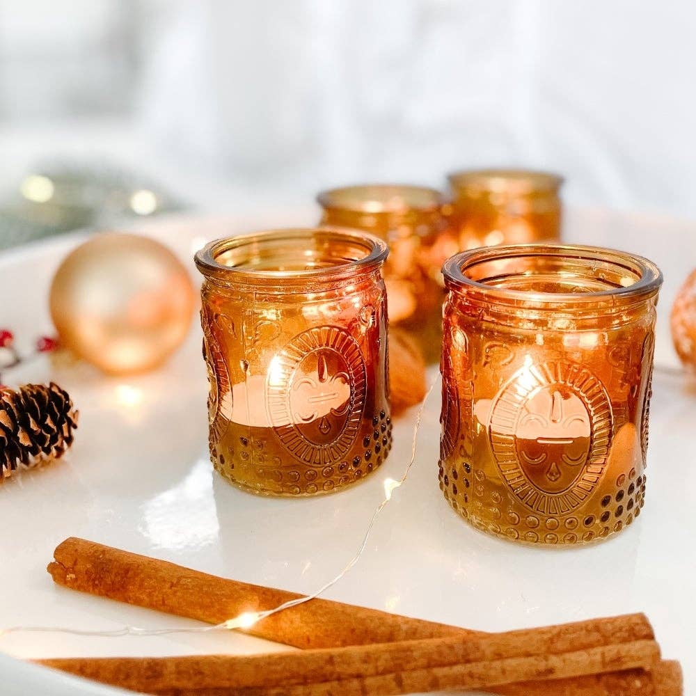 Mellow Monkey set of 4 vintage amber glass tea light holders with embossed patterns on a festive tabletop