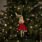 Mellow Monkey vintage-style fabric elf ornament with a gold hat, red shirt, and posable limbs hanging on a tree.
