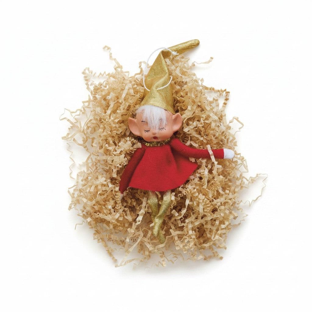 Mellow Monkey vintage-style fabric elf ornament with a gold hat, red outfit, and posable limbs in shredded paper