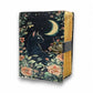 Mellow Monkey vintage leather spellbook with black cat, moon, and floral design. Features deckle edge paper and a clasp closure.