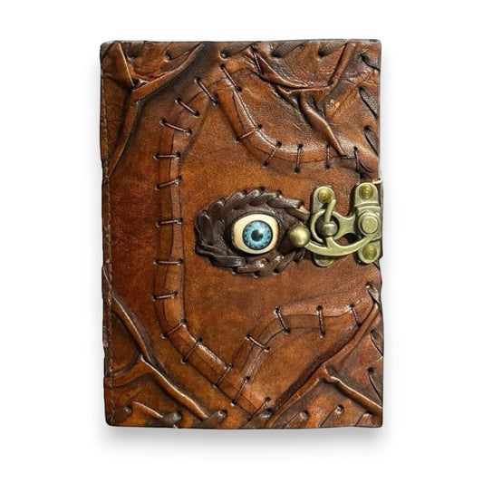 Mellow Monkey vintage brown goat leather spellbook with a blue eye and brass clasp, 5x7 inches, 200 pages.