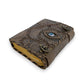 Mellow Monkey Hocus Pocus vintage leather spellbook with an eye design and brass clasps. 5x7 inches, 200 pages.