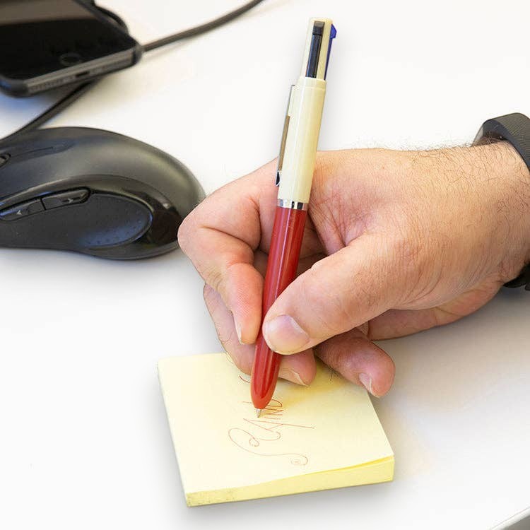 Mellow Monkey vintage multi pen with red and cream body writing on a yellow sticky note