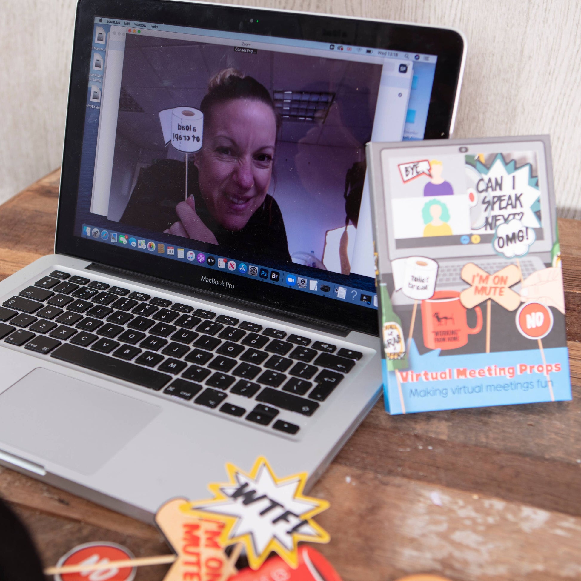 Mellow Monkey virtual meeting props featuring humorous handheld signs for video calls displayed next to a laptop.