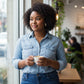 Mellow Monkey handmade vodka and energy drink stud earrings worn by a woman holding a coffee cup in a cafe