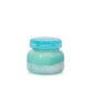 Mellow Monkey Volcano Artisan candle in a turquoise jar with textured sea glass finish and lid. Sugared citrus and tropical fruit scent.
