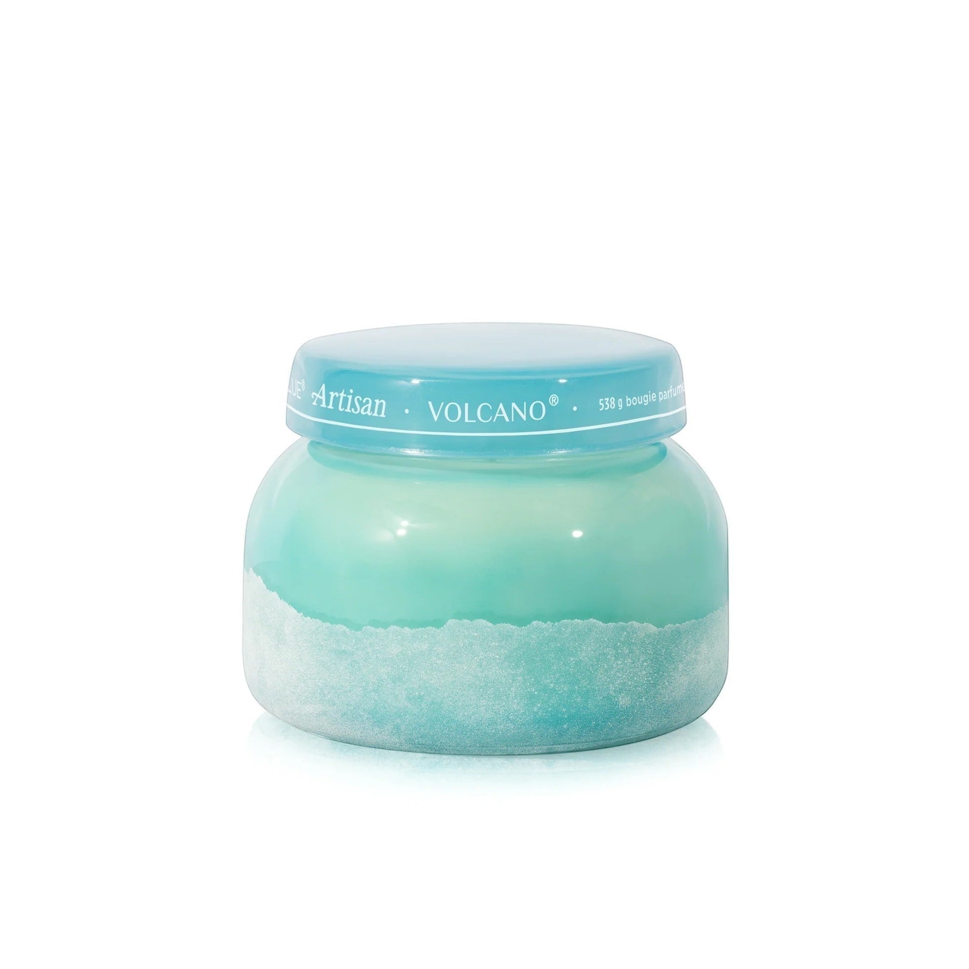 Mellow Monkey Volcano Artisan Signature candle in a turquoise sea glass finish jar with the lid on.