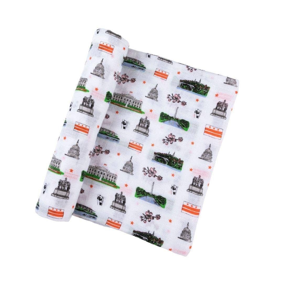 Mellow Monkey Washington DC print muslin baby swaddle blanket featuring monuments, cherry blossoms, and flag motifs.