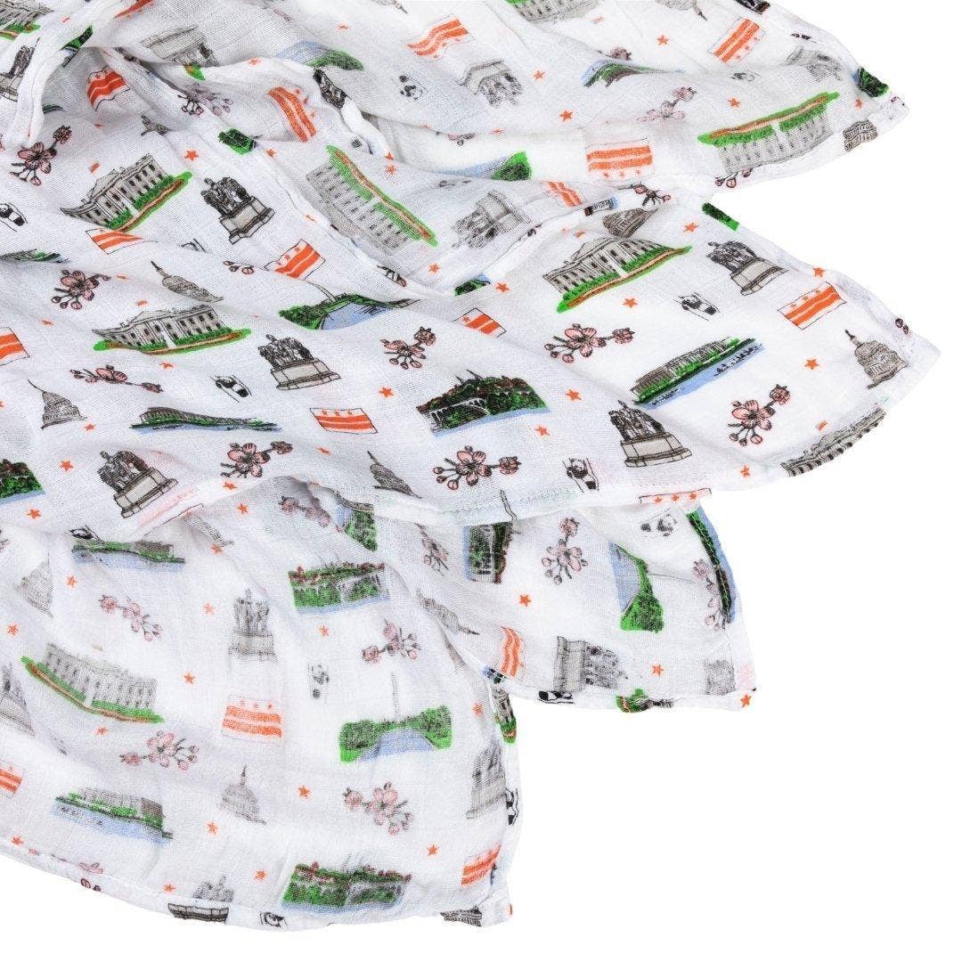 Mellow Monkey Washington DC print muslin baby swaddle blanket featuring monuments, cherry blossoms, and flag motifs.