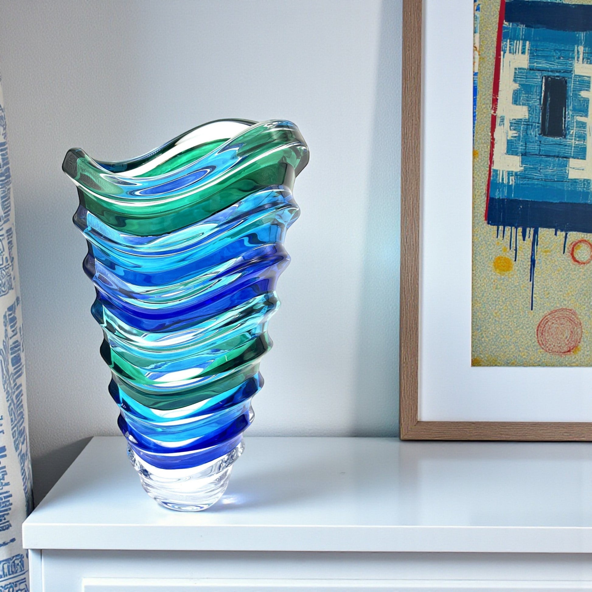 Mellow Monkey Wave Venetian crystal glass vase in aqua, blue, and green with a wave design. 12-inch height.