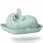 Mellow Monkey aqua ceramic whale butter dish with lid, tail handle, and wave rim detail.