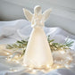 Mellow Monkey white ceramic angel LED Christmas decor holding a star with warm glowing lights on a festive fabric base