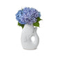 Mellow Monkey white ceramic fish vase, 12-in, holding blue hydrangeas. Whimsical decor accent.