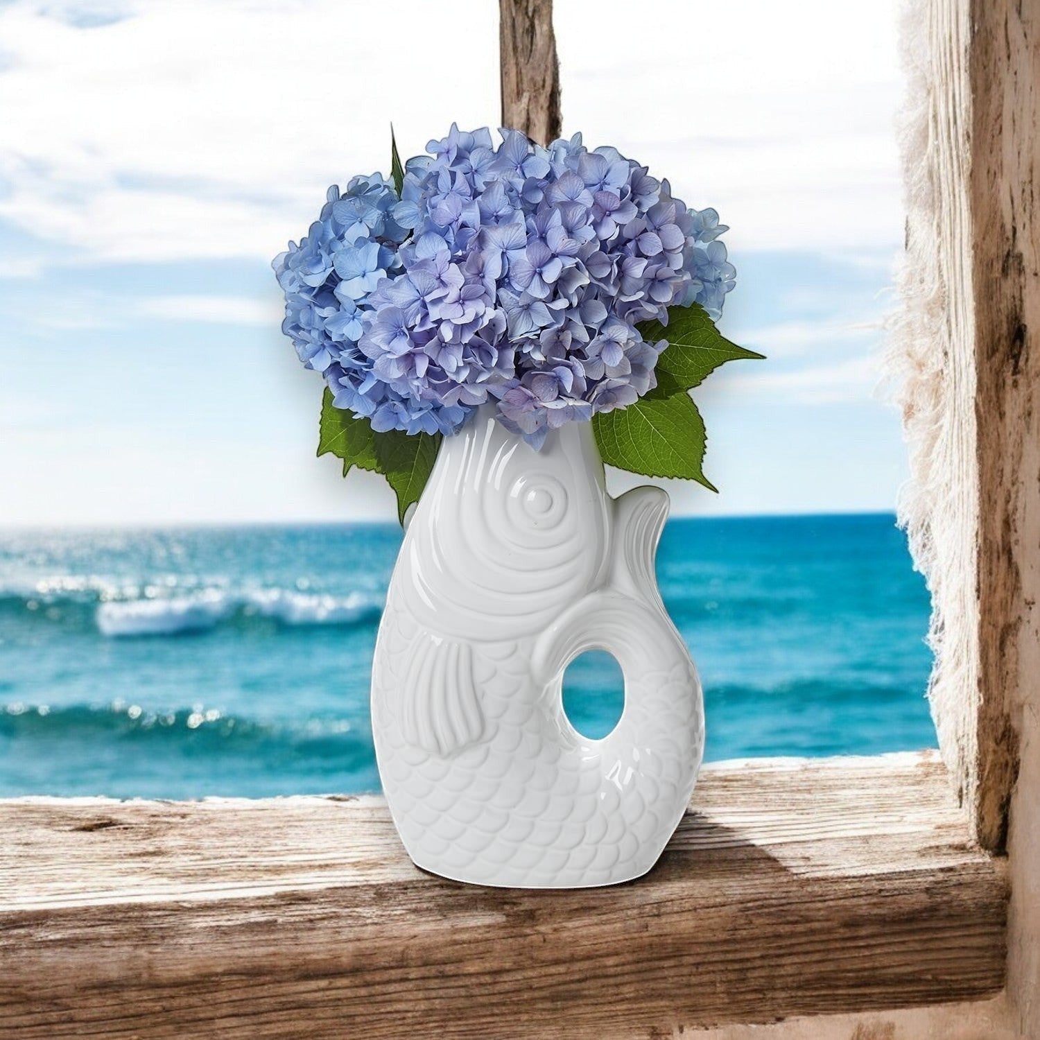 Mellow Monkey white ceramic fish vase with blue hydrangeas, 12-in tall, whimsical coastal decor