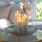 Mellow Monkey set of three white flameless LED pillar candles in glass holders on a decorative bowl