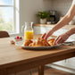 Mellow Monkey VIDA Havana Oval Tray in white, made of luxury melamine, serving croissants and berries.