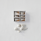 Mellow Monkey set of six small white stoneware Christmas trees in a gift box for holiday mantel and table decor.